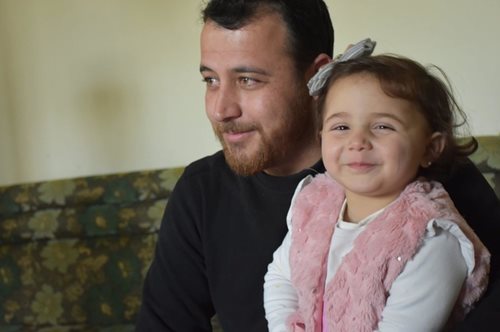 «Είναι το παιχνίδι μας». Μπαμπάς στη Συρία μαθαίνει στην κόρη του να γελάει όταν πέφτουν οι βόμβες